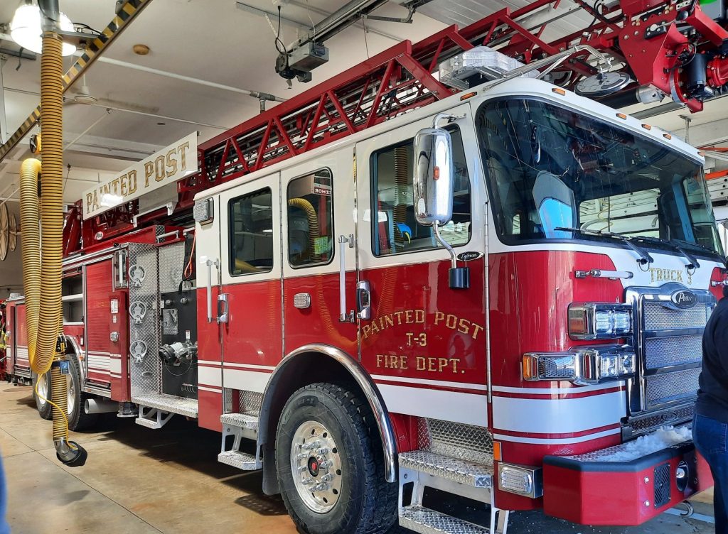 Village of Painted Post red and white fire truck with gold letters Painted Post T-3 Fire Dept. on red background.