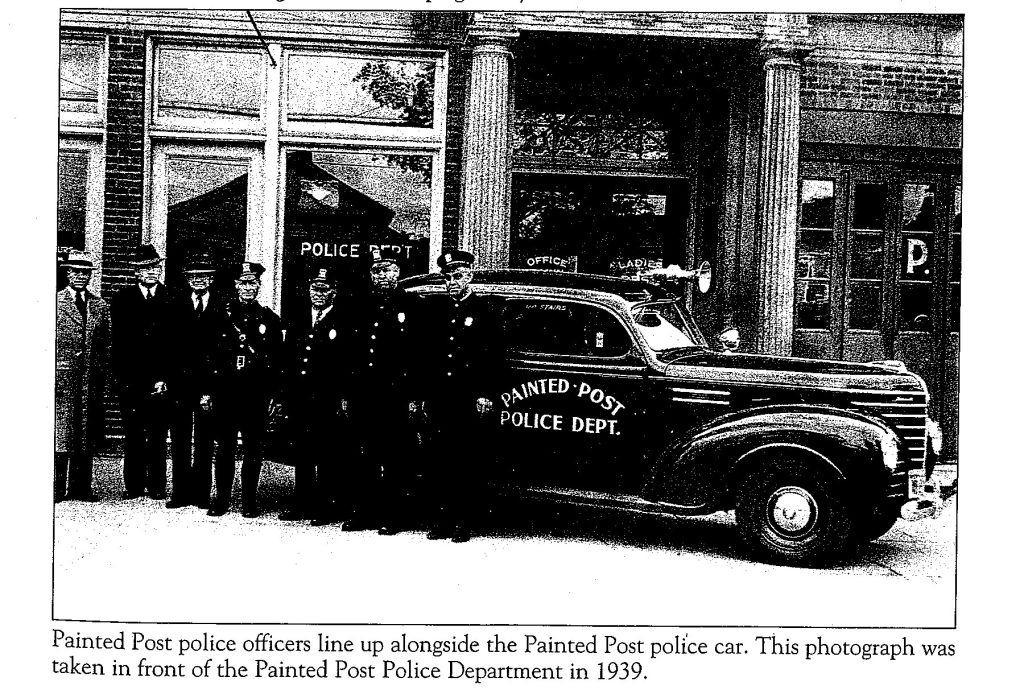Painted Post police officers line up alongside the Painted Post police car. This photograph was taken in front of the Painted Post Police Department in 1939.